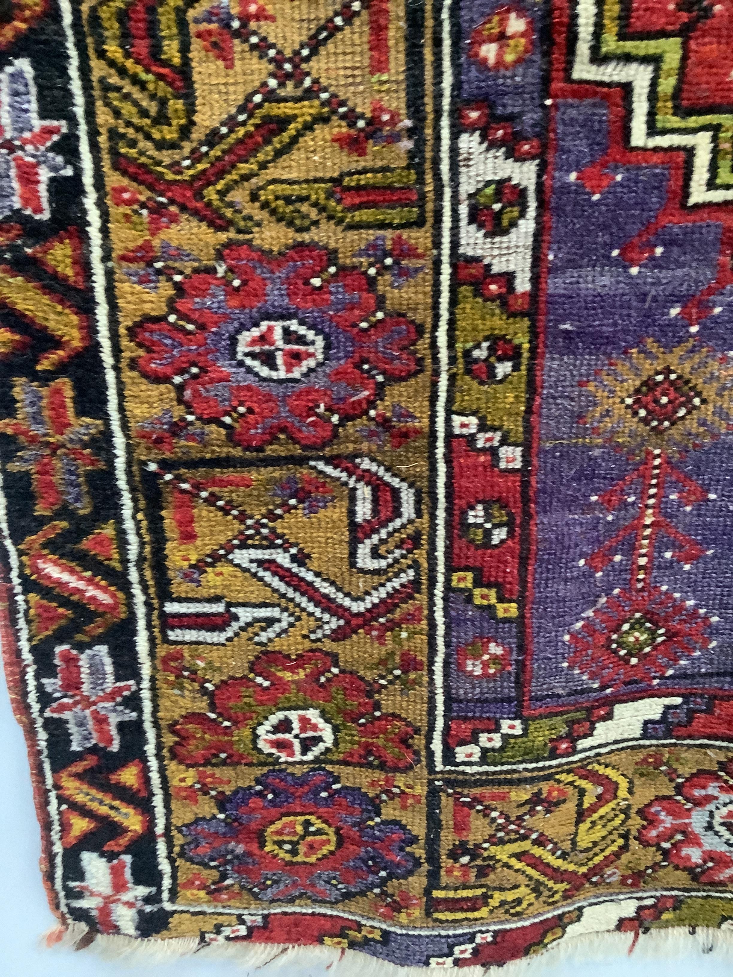 A Turkish purple ground rug, 157 x 109cm